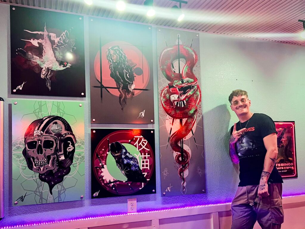 Image of Quinn Warren next to his Monthly Artist gallery